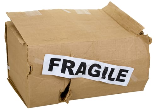 Crumpled cardboard box with inscription "fragile" on white