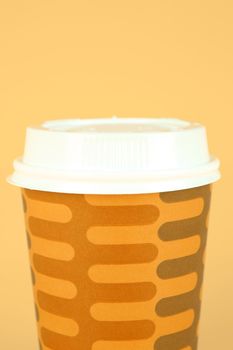 Takeaway coffee cups isolated against an orange background