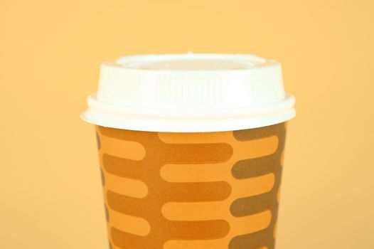 Takeaway coffee cups isolated against an orange background