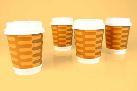 Takeaway coffee cups isolated against an orange background