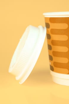 Takeaway coffee cups isolated against an orange background