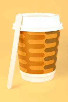 Takeaway coffee cups isolated against an orange background