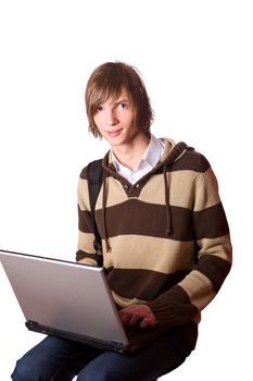 Young man doing homework on own laptop isolated on white