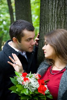 Two young lovers talking to each other in park