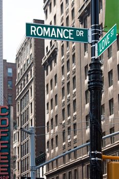 A sign post at the intersection of two streets reading ROMANCE DR and LOVE ST. Or remove the words and insert your own to easily customize the concept.