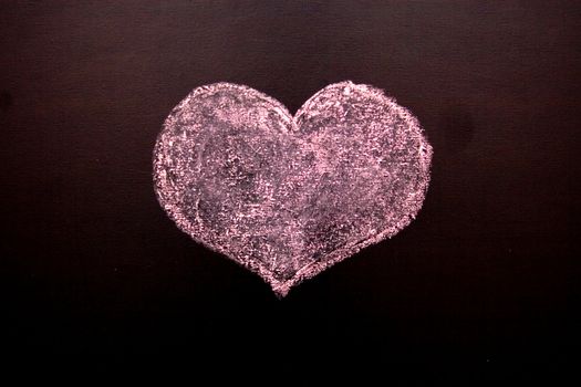 On a blackboard red heart and a word love is drawn
