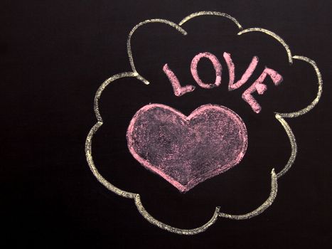 On a blackboard red heart and a word love is drawn