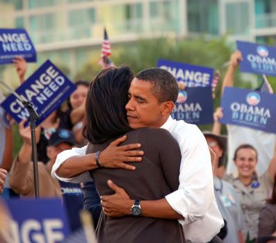 Barack Obama hugging his wife Michele after being introduced by her to a crowd of over 30,000 supporters at a rally in Bay Front Park,Miami,Florida in October 2008