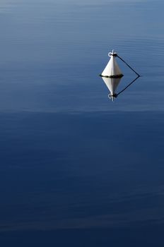 Detail of a white buoy in a calm sea