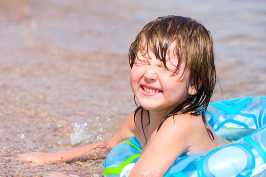 Happy child in sea water having fun