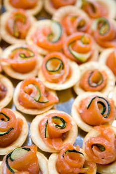 Lots of salmon canapes with cucunber closeup