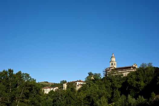 Ancient Italian village atop a hill at sunset