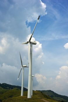 Three wind turbines atop a mountain