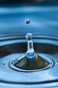 Bouncing water drops in blue background