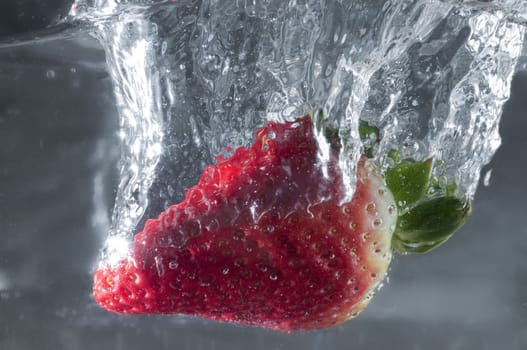A strawberry dip into water
