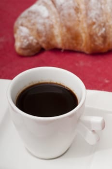 Continental breakfast with espresso coffee and a croissant