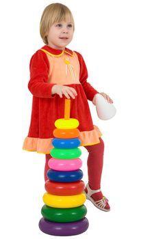 Little girl and toy pyramid on the white background