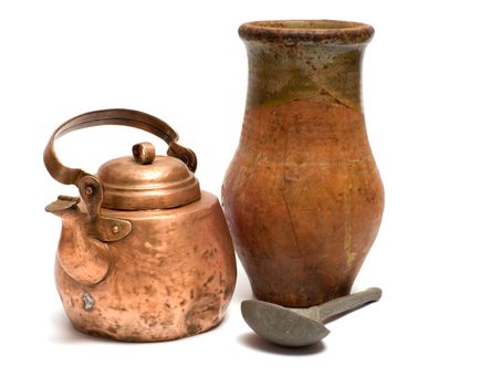 The old copper kettle, pewter spoon and ceramic  pot on a white background.