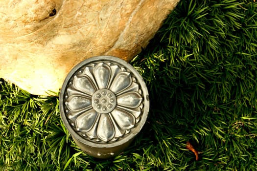 Metallic Floral Decoration with grass and stone in park under sunset