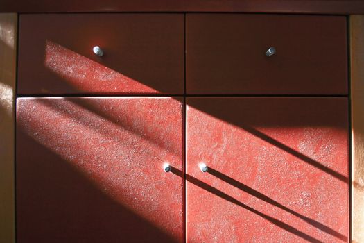 Cupboard with dust in light and shadow