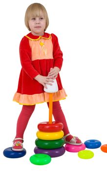 Little girl and toy plastic pyramid on white