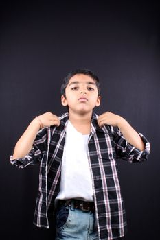 A stylish Indian boy wearing his shirt.