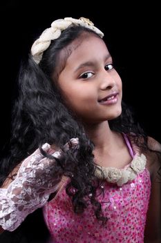 A portrait of a cute Indian girl in pink dress.