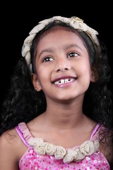 A portrait of a happily smiling Indian girl..