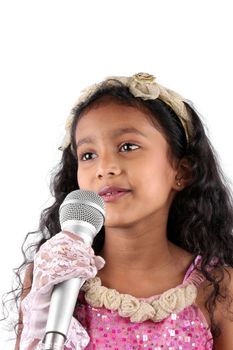 A talented little Indian girl singing, on white studio background.