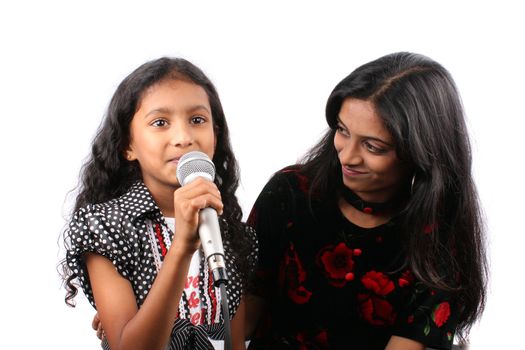 An elder sister boosting her little sisters confidence for a public performance.