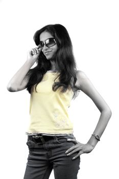 A portrait of a glamorous Indian teenage girl wearing sunglasses, on white studio background.