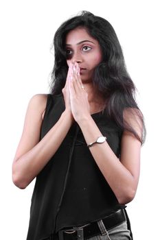 A devoted Indian teenage girl praying to god, on white studio background.