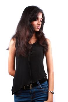 A stylish Indian teenage model posing in black top and denim jeams, on white background.