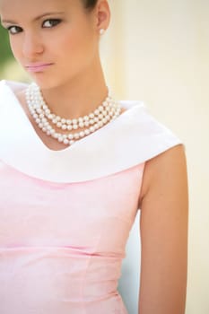 closeup portrait of the cute girl with pearl necklace