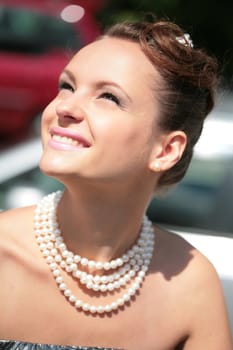 close-up portrait beautiful smiling girl with pearl necklace
