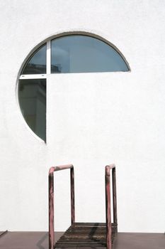 abstraction, architectral fragments of the modern building, futuristic window in concrete wall and metallic banisters