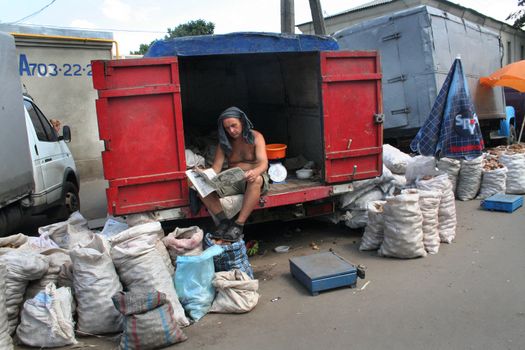 The seller of a potato reading The newspaper 05 08 2007 Kharkov Ukraine