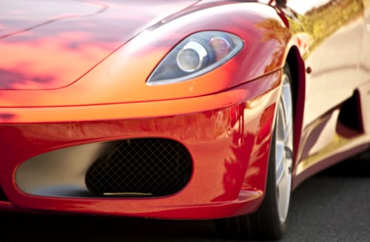 Detail of a red sports car on the road
