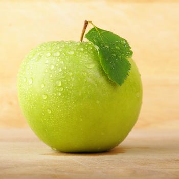 green apple on wood with copyspace showing healthy food concept