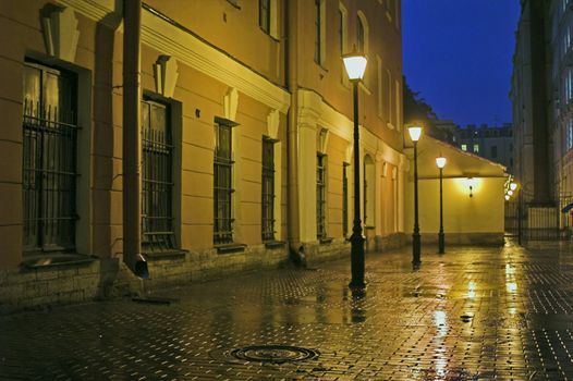 Backyard with street lamps and stone pavement at evening in Saint Petersburg, Russia.