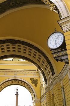 Old-style Public Clocks under the General Army Staff Building Arch in Saint Petersburg, Russia. The inscription on the clock-face: State Chamber for Measuring and Weighing (upper, 19th century designation, now out of use) and Exact Time (bottom).