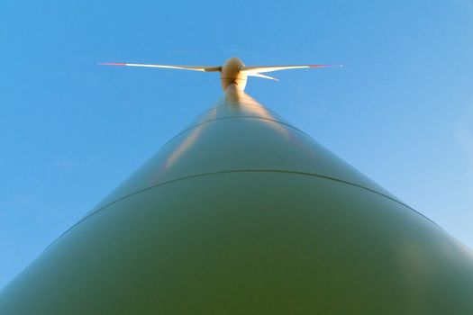 A windturbine on the blue sky background