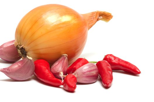 Onion garlic and red pepper on a white background.