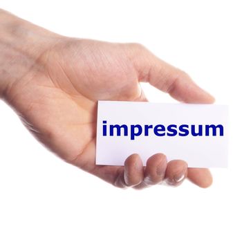 impressum concept with hand word and paper