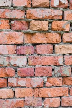 Cracked and old red brick wall closeup texture