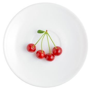 Simple white saucer with four fresh and red cherries. Isolated on white background