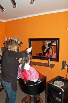 An image of a Female hair coloring at a salon