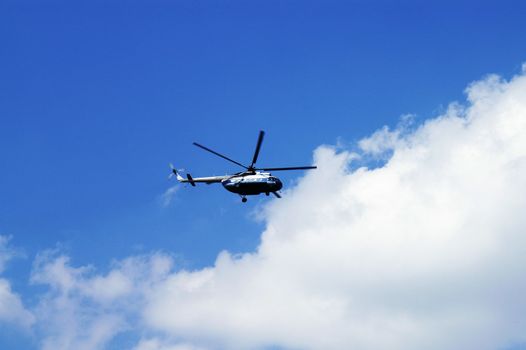 Civil Helicopter in Cloudy Skies