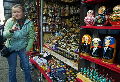 ST PETERSBURG, RUSSIA-MAY 5, 2008: Street vendor offering tourists to buy doll souvenirs depicting Lenin, Putin and Medvedev