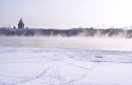 Fogged Neva River and St. Isaac Cathedral (left in the background) in Saint Petersburg. A view from Schmidt's Embankment.